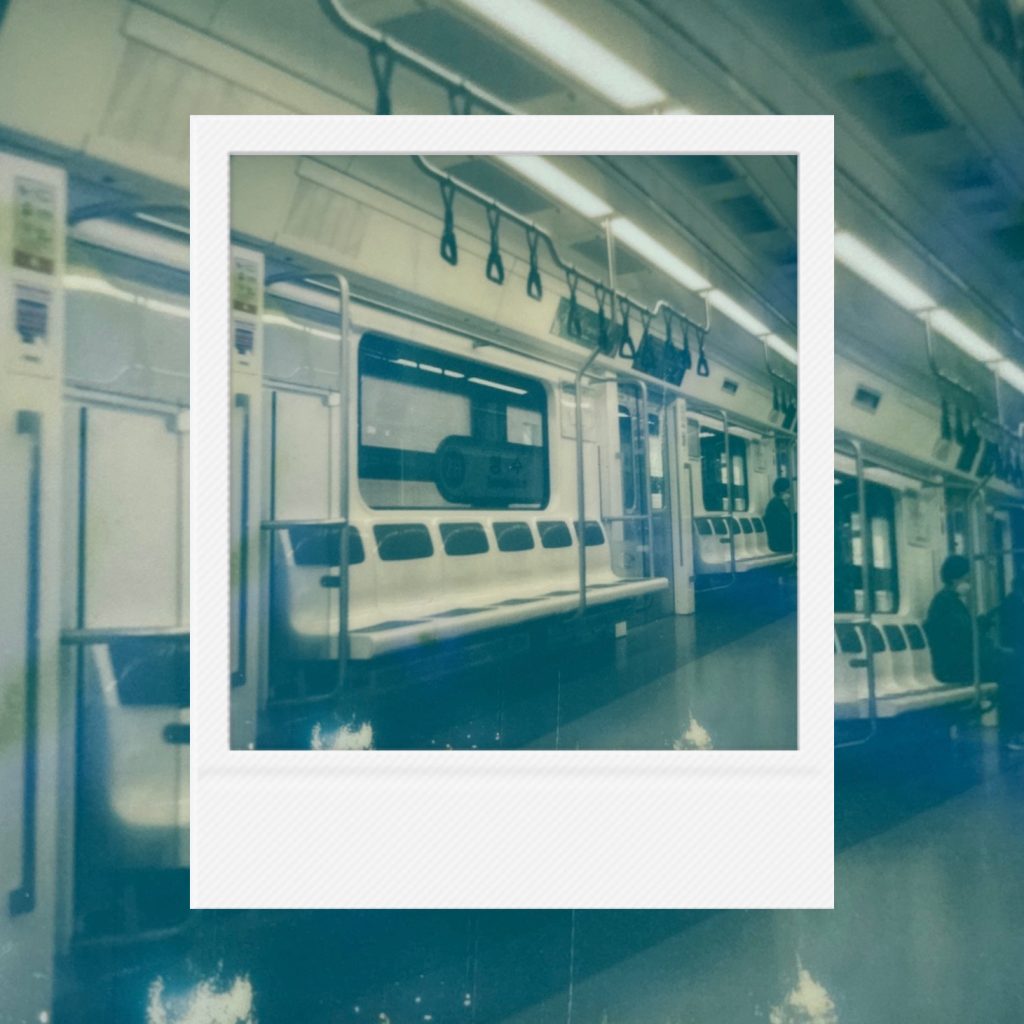 The dreamy blue stillness flowing over an empty subway seat where someone once stayed, capturing the lonely trajectory of daily life within an analog film frame