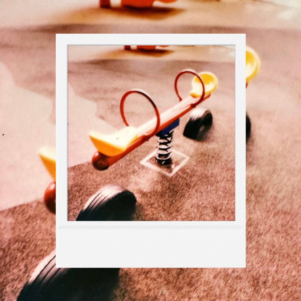 The quiet balance of a seesaw standing in an empty playground capturing the tender afterimages of childhood in an analog film frame
