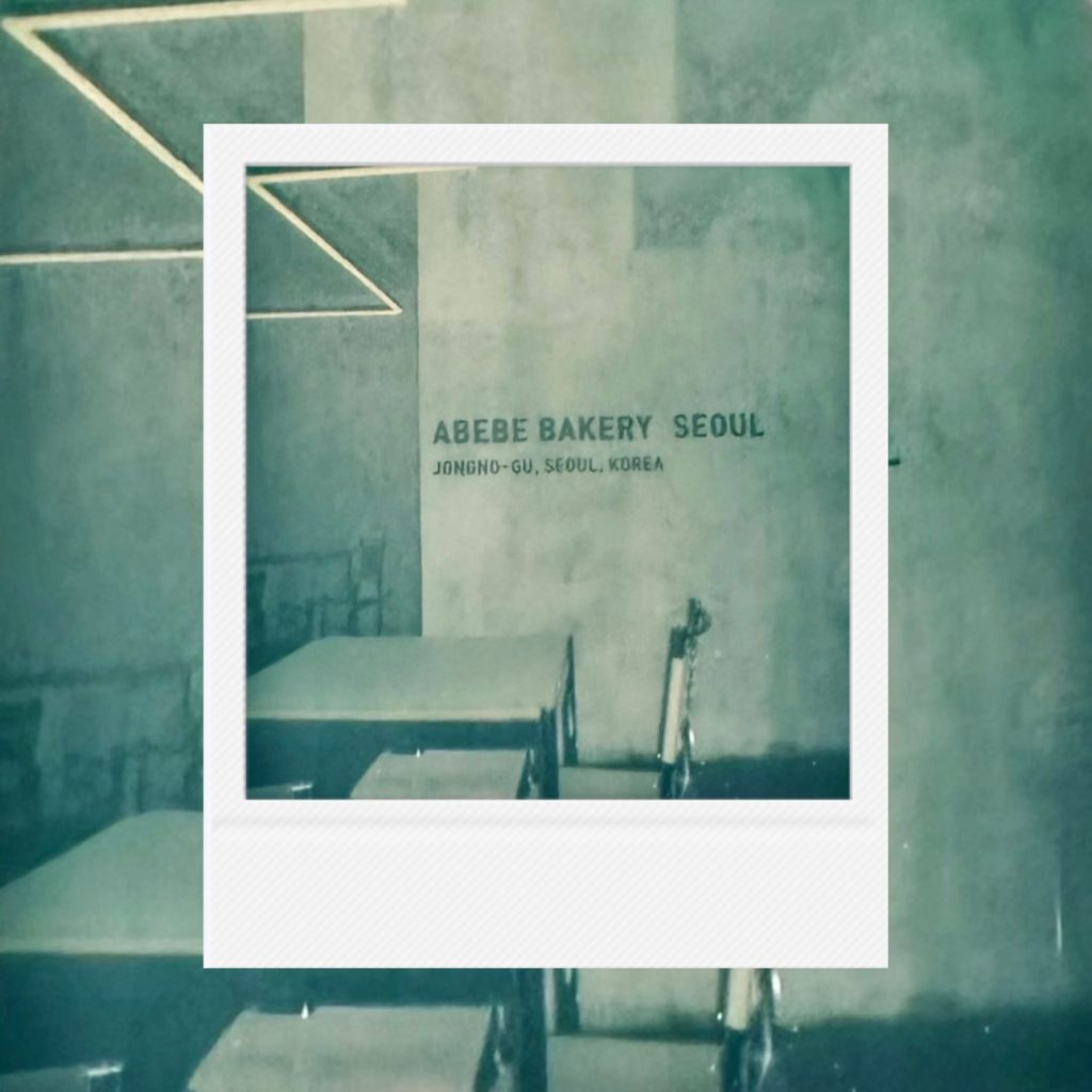 The quiet breath of the afternoon preserved in faint film tones capturing a lyrical record of a bakery within a Polaroid frame