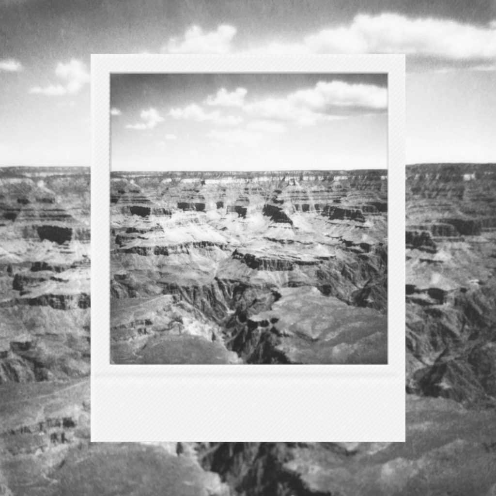 The variation of light and shadow spreading over the contours of the earth crafted by eons of time, capturing the silence of sacred nature within a Polaroid frame