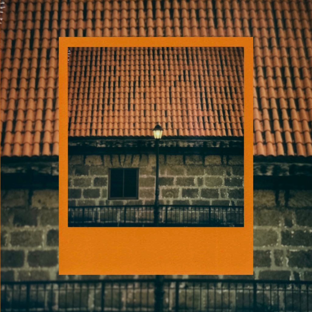 The air of medieval times flowing over the antique stone walls and red tiles of Intramuros, Manila, capturing an exotic daily record within an analog film frame