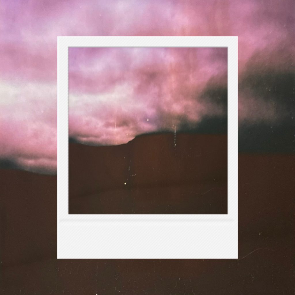 A quiet meeting of rose-colored clouds and distant darkness,capturing the delicate tension between fading light and approaching rain